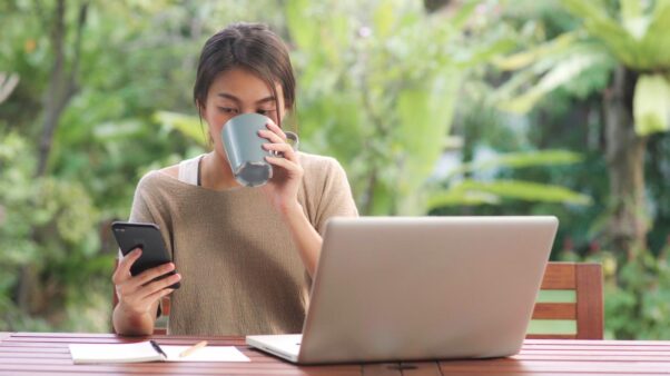 Student studying online on a laptop outdoors